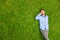 Man laying on a grass talking on a mobile phone Royalty Free Stock Photo
