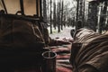 Man laying inside the camping tent pov with amazing forest woods landscape outside - people travel alternative lifestyle sleeping