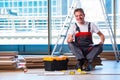 The man laying laminate flooring in construction concept Royalty Free Stock Photo