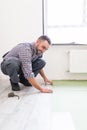 Worker Man laying laminate flooring in construction concept Royalty Free Stock Photo