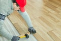 Man laying laminate flooring in construction concept Royalty Free Stock Photo