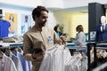 Man laying out clothes in store Royalty Free Stock Photo
