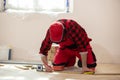 Man laying parquet flooring, worker joining parquet floor. The builder, man is engaged in laying laminate wood floor in the room Royalty Free Stock Photo