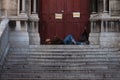Man laying on the steps of the Sacred heart Basilica in Paris