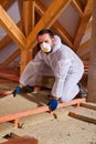 Man laying thermal insulation layer on building Royalty Free Stock Photo