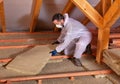 Man laying thermal insulation