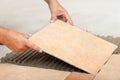 Man lays ceramic floor tiles - closeup Royalty Free Stock Photo