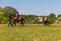 Man leading a horse with young woman and her child ride Royalty Free Stock Photo