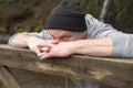 Man leaning against an old wooden gate outdoors Royalty Free Stock Photo