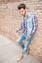 Man leaning on brick wall looking down Royalty Free Stock Photo