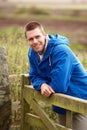 Man leaning on country gate