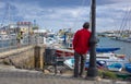 Man leaning on a lamp post