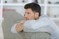 Man leaning over back sofa Royalty Free Stock Photo