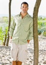 Man leaning on tree at beach Royalty Free Stock Photo