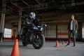 Man learning to ride bike at private school maneuvering between cones