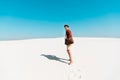 Man with leather bag on sandy beach with footprints Royalty Free Stock Photo