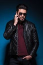 Man in a leather jacket is scratching his beard Royalty Free Stock Photo