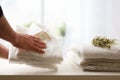 Man leaving clean shirts on white table and window background Royalty Free Stock Photo