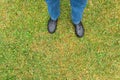 Man legs with pants and black shoes on wet sward