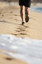 Man legs running on the sand of a beach Royalty Free Stock Photo