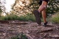 Man legs running on trail in the mountains