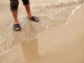 Man is legs on the sand beach Royalty Free Stock Photo