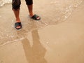 Man is legs on the sand beach Royalty Free Stock Photo