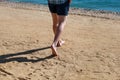 Man legs on sand. Male feet walking on beautiful sandy beach of hotel resort in Egypt, doing and leave footprints in sand. Royalty Free Stock Photo