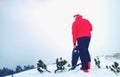 Man legs with snowshoes walk in snow in winter mountains.