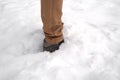 Man legs standing in fresh snow. Footprints of shoes in the snow. Snowdrifts in the winter
