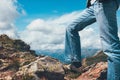 Man legs standing on top of cliff