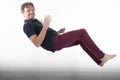 Man in levitation falling floating up at home in house white wall