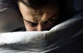 Man lies in bed and sees nightmares, can not fall asleep from fear, bad sleep, insomnia Royalty Free Stock Photo
