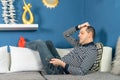Man lies bored on the couch and watches TV Royalty Free Stock Photo