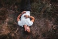 Man lies on the grass in the middle of the forest relaxing - resting. Place for text or advertising. Top view Royalty Free Stock Photo