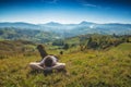 Man lies on a hill in a grass and enjoy the valley Royalty Free Stock Photo