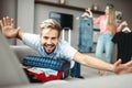 Man lies on overfilled suitcase, fees on journey Royalty Free Stock Photo