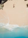 Man lies and sunbathing on the sand at tropical ocean beach. Drone view Royalty Free Stock Photo