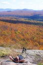 Man lies in sunshine seeing fall colors in trees Royalty Free Stock Photo