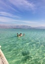 A man lies on the surface of the water at the Dead Sea in Jerusalem Royalty Free Stock Photo