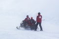 Lifeguards on a snowmobile in the fog