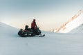 Man lifeguard snowmobile rides in the mountains.