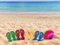 Man lifestyle four relax flip flops on orange sand and volleyball Royalty Free Stock Photo