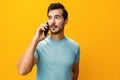 Man mobile happy copy phone communication portrait smiling yellow phone cyberspace space studio smartphone technology Royalty Free Stock Photo