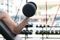 man lift dumbbell in gym. bodybuilder male working out in fitness center. sport guy doing exercises in health club. Royalty Free Stock Photo