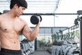 man lift dumbbell in gym. bodybuilder male working out in fitness center. sport guy doing exercises in health club. Royalty Free Stock Photo