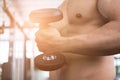 man lift dumbbell in gym. bodybuilder male working out in fitness center. sport guy doing exercises in health club. Royalty Free Stock Photo