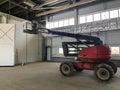 Manlifting vehicle inside industrial building. Man lifting platform machinery Royalty Free Stock Photo