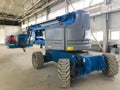 Manlifting vehicle inside industrial building. Man lifting platform machinery Royalty Free Stock Photo