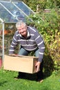 Man lifting heavy box correctly. Royalty Free Stock Photo